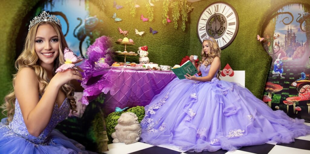 villas photoshoot at Villa Turquesa in Homestead FL – quinceañera in a lavender ball gown reading a book in a whimsical Wonderland-themed backdrop.