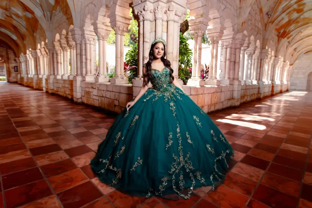 Castle quince photography at the Spanish Monastery: teal gown centered in a cloister with repeating stone arches.