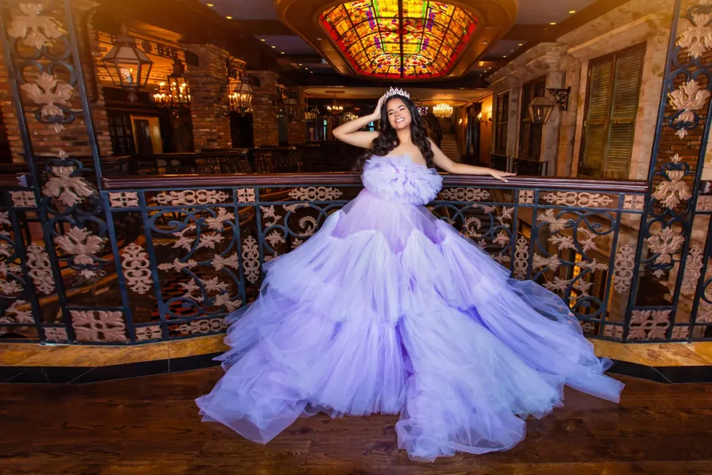 Royal quince photos at The Cruz Building: lilac tulle gown under stained-glass ceiling and warm golden lights.