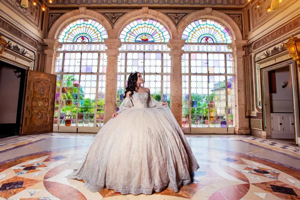 Palace quince photography at Vizcaya Museum: ivory ball gown under stained glass windows and marble mosaic floors.