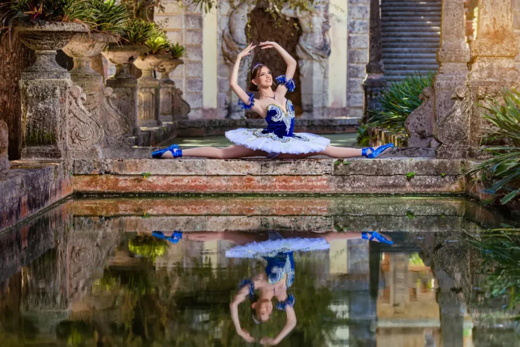 Royal quince photos at Vizcaya Museum & Gardens: ballerina pose in blue tutu reflected on the water by stone fountains.