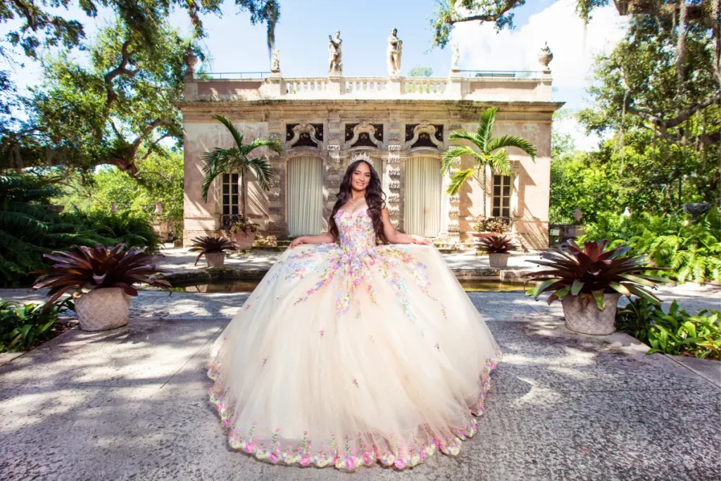 Castle quinceanera shoot at Vizcaya Museum: floral gown in a tropical garden with palm trees and classical architecture.