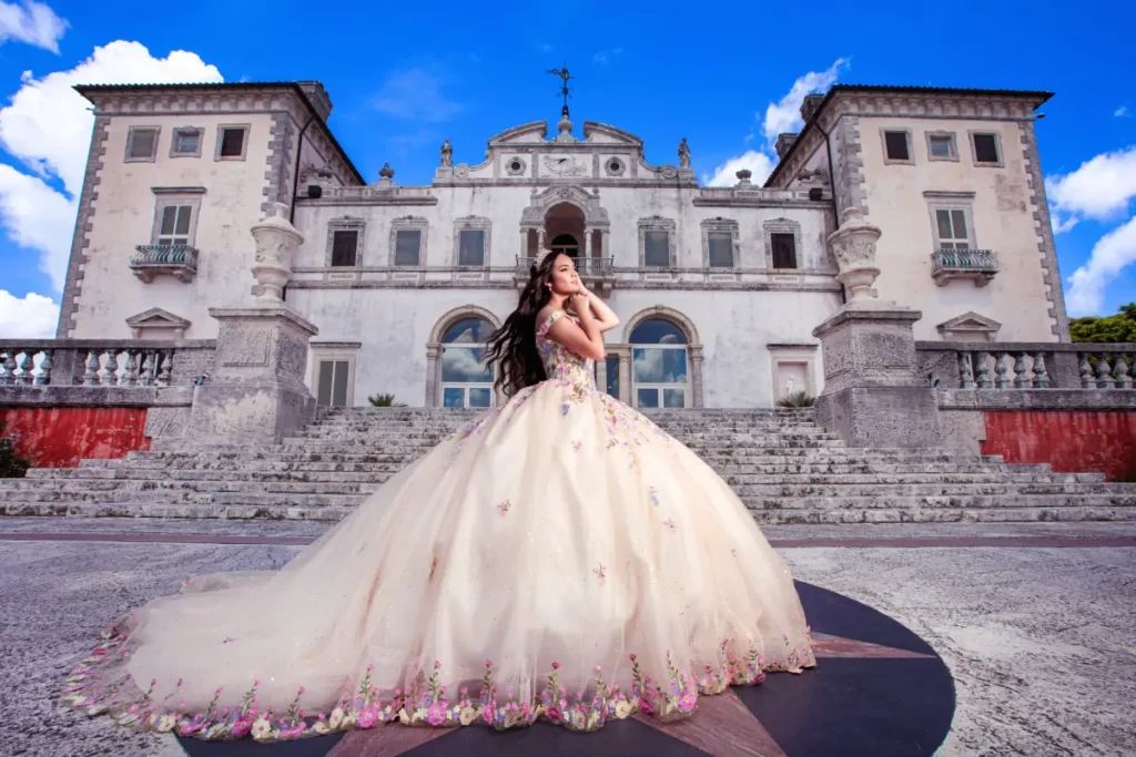 Castle quince photography at Vizcaya Museum: floral ball gown in front of the grand villa under a vivid blue sky.