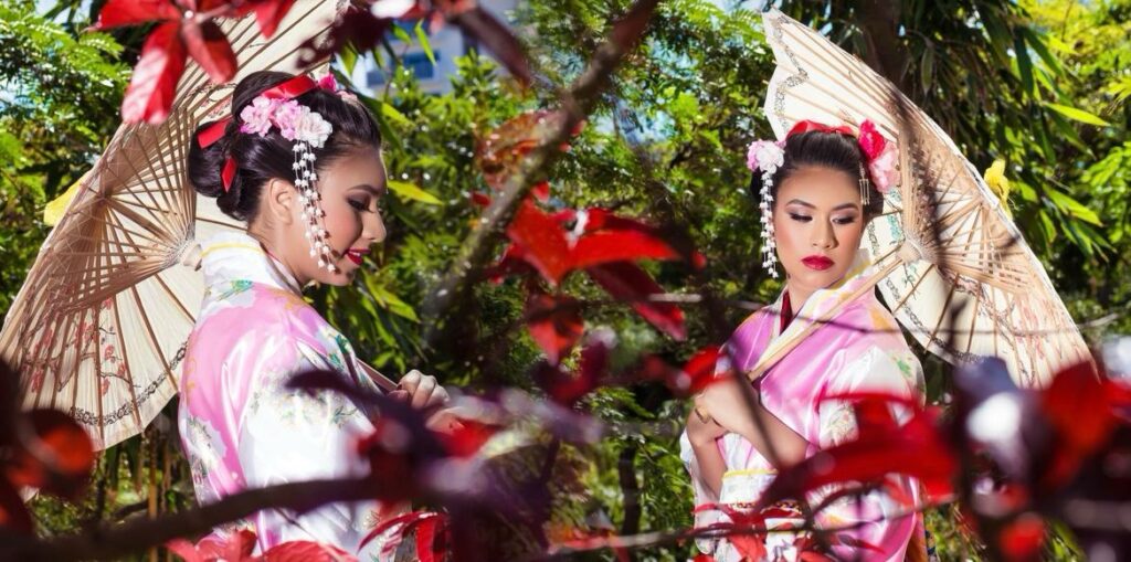 Asian-inspired quinceañera portrait with traditional kimono and parasol.